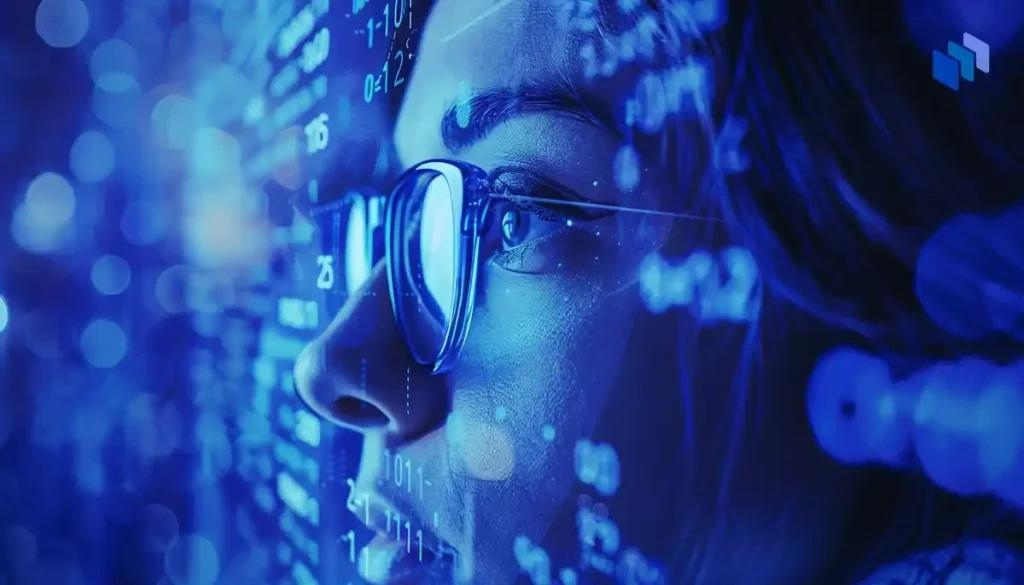 En närbild av en person med glasögon som tittar på digitala data och kod, upplyst i ett blått sken som symboliserar teknologins värld.